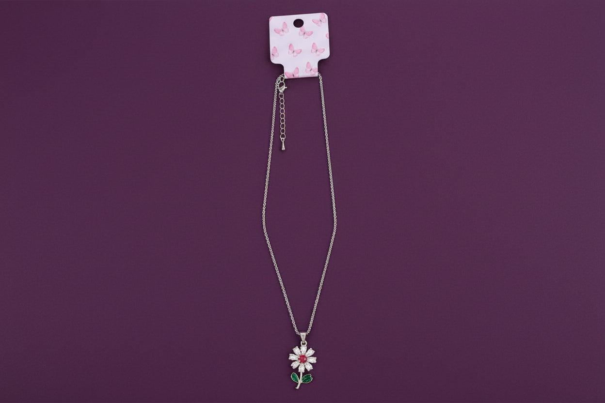 Gold flower necklace on purple background Juanita Boutique
