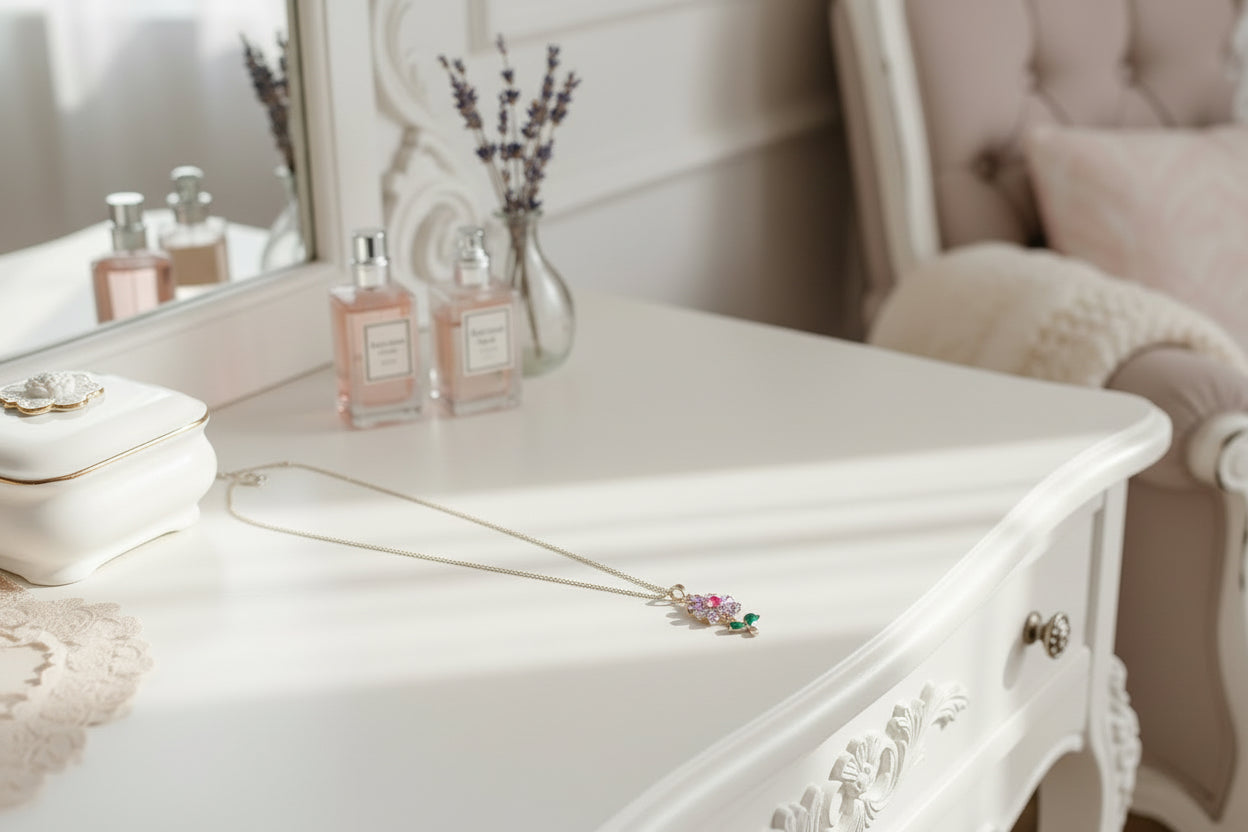 Gold flower necklace displayed on white dresser Juanita Boutique.