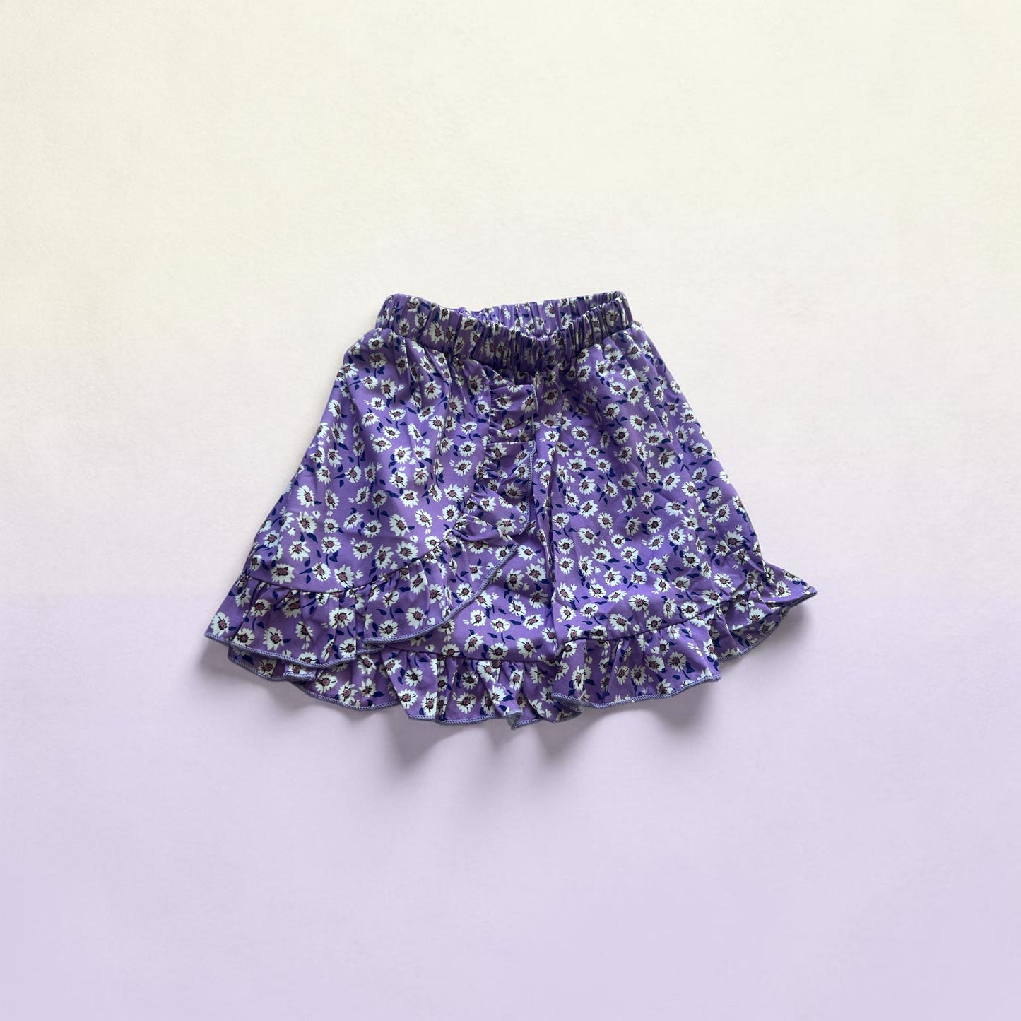 Purple floral skirt on a light gray background