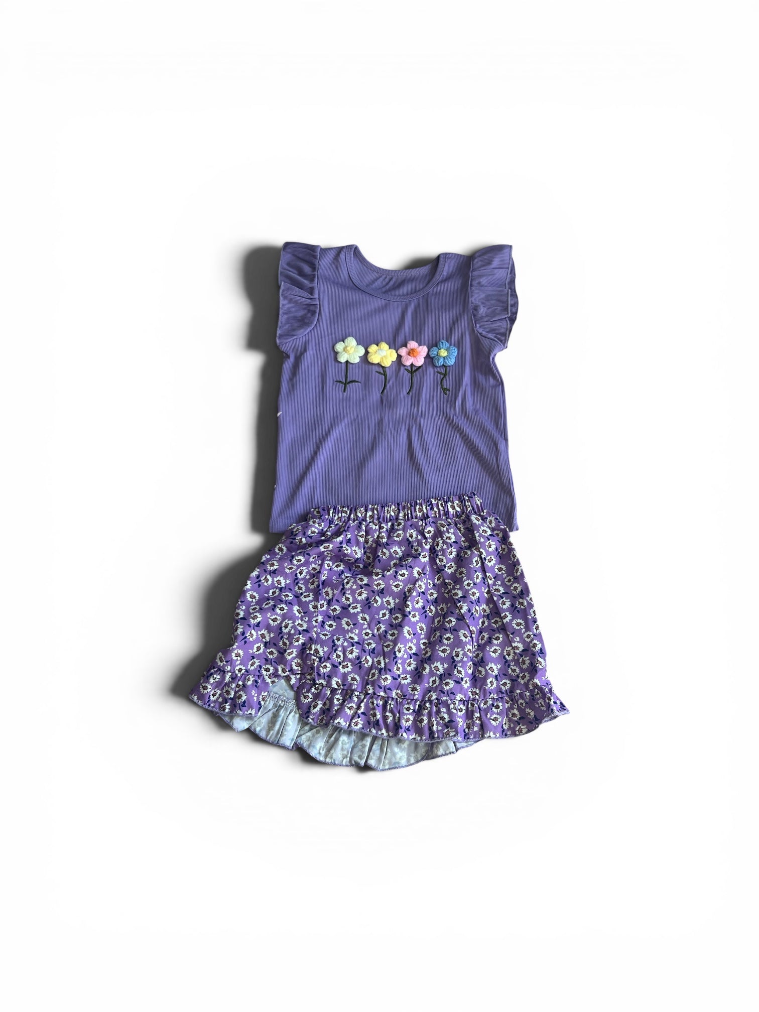 Purple dress with floral design on a white background