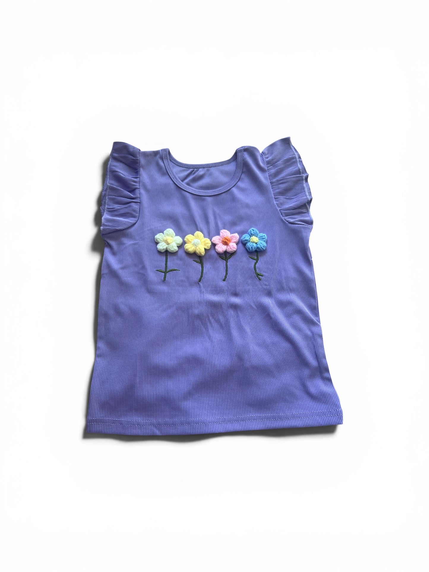 Purple sleeveless top with floral designs on a white background