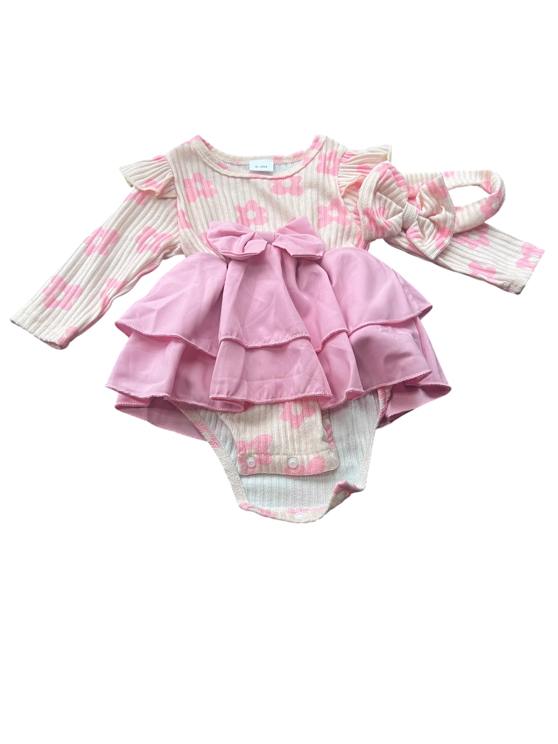 Pink baby outfit with ruffled top and matching bloomers on a white background