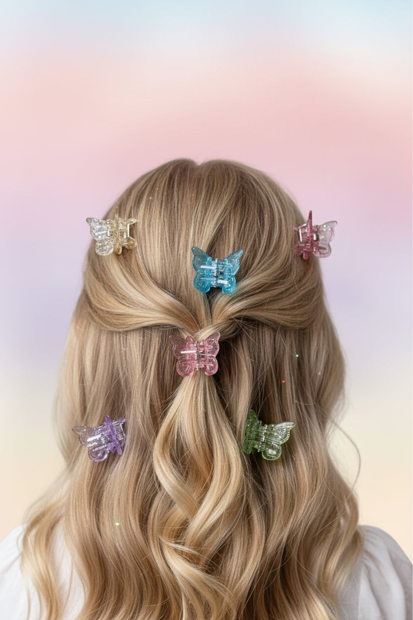 Blonde hair styled with colorful butterfly hair clips on a gradient background