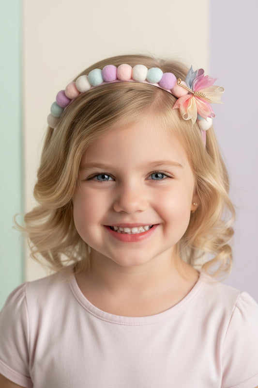 Pastel-colored beaded headband with a decorative bow on a white background