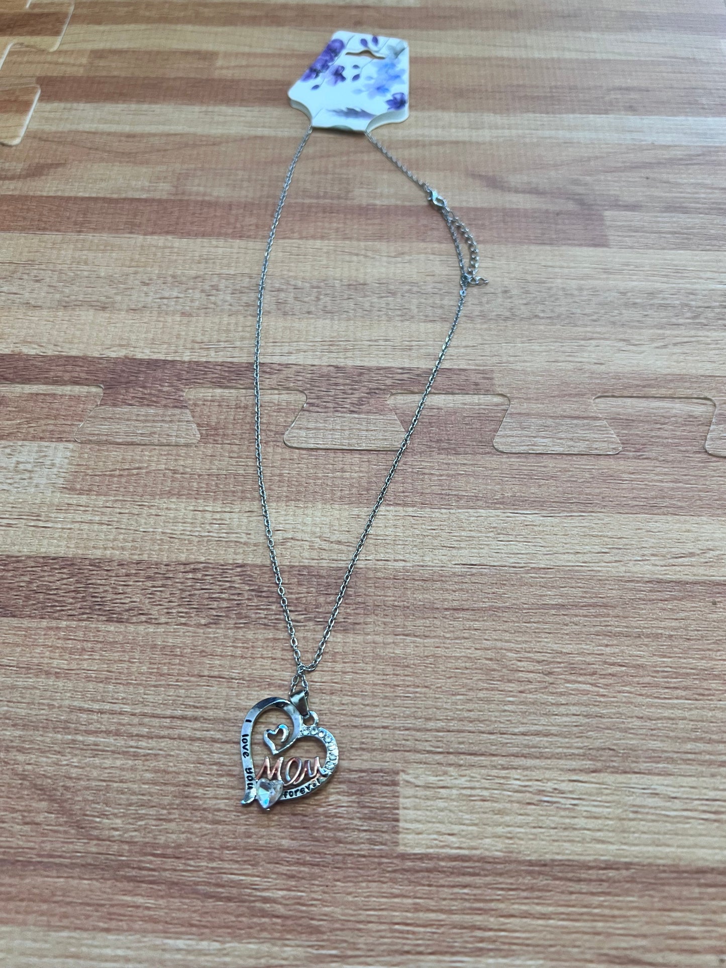 Necklace with a heart-shaped pendant on a wooden surface