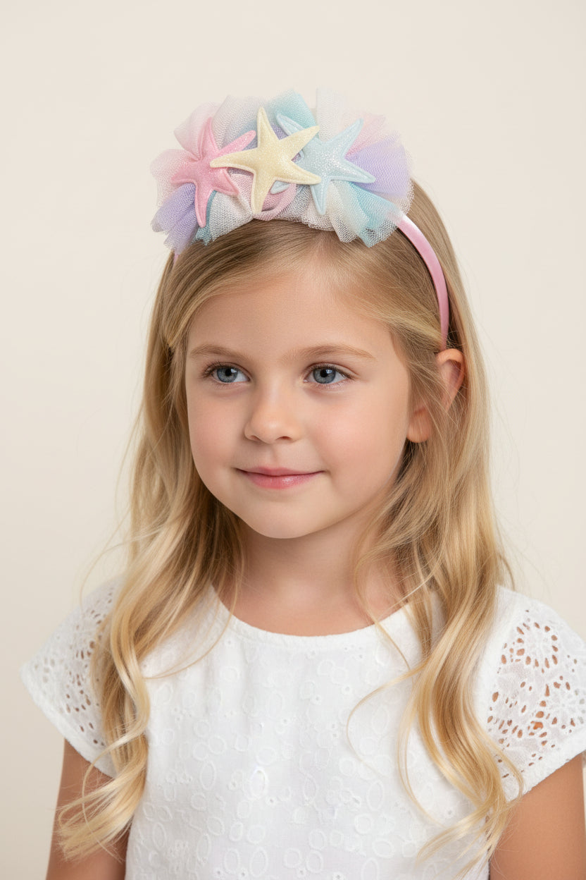 Pastel-colored headband with star-shaped decorations on a white background on a model
